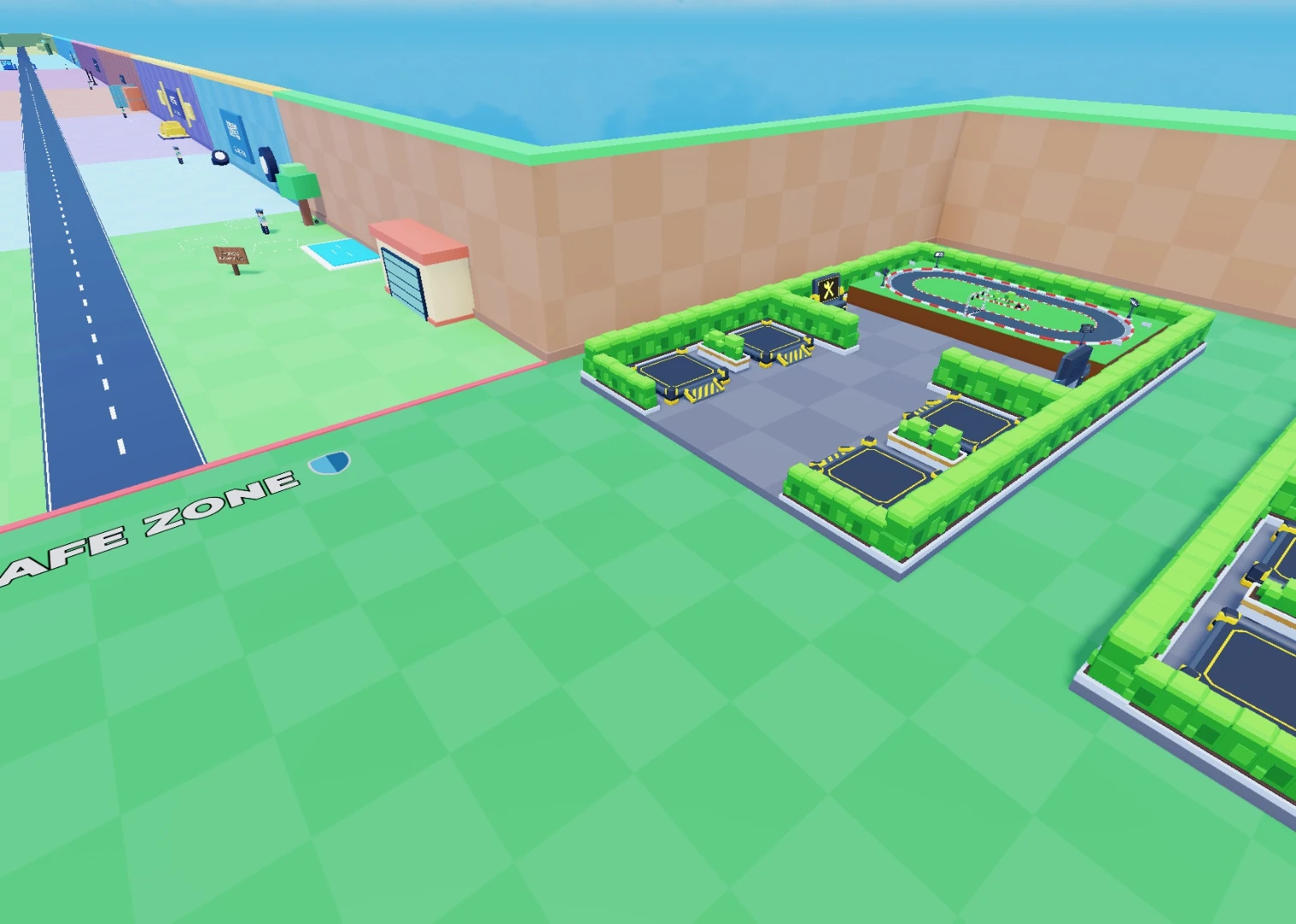 A player's hedge-lined base and Tycoon race track beside the road into the themed zones.
